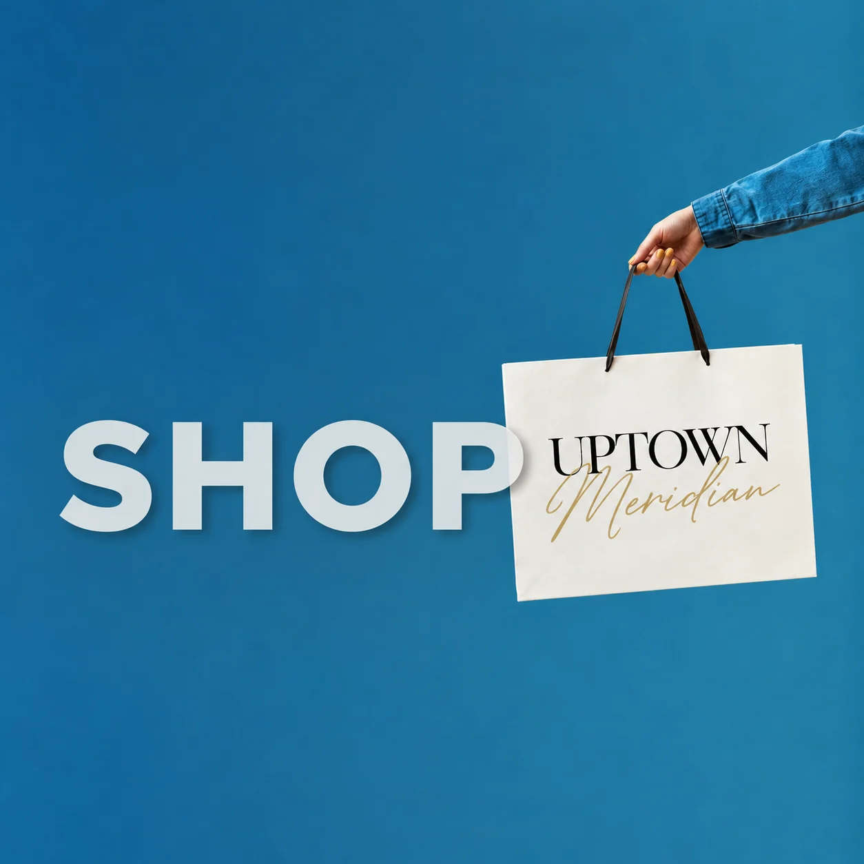 Shop Uptown Meridian: a hand holding an Uptown Meridian shopping bag